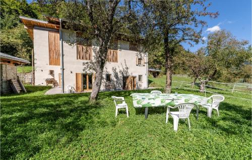 a table and chairs in the yard of a house at Stunning Home In Ledro With Wifi in Ledro
