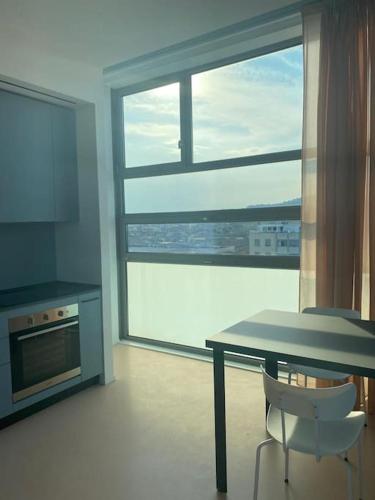 a kitchen with a table and a large window at Matteotti28 in Pesaro
