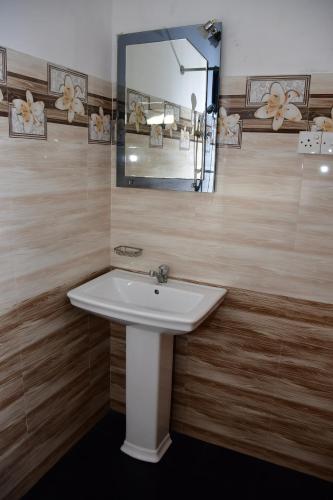 a bathroom with a sink and a mirror at Sholay Villa in Galle