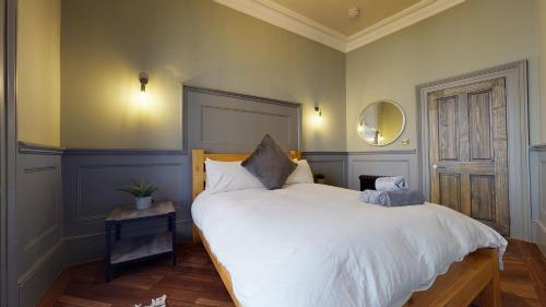 a bedroom with a large white bed and a mirror at Barbican Boutique Luxury Apartments & Rooms, Plymouth in Plymouth