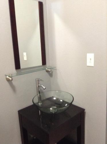 a bathroom with a glass sink and a mirror at Villa Ensenada Honda in Culebra