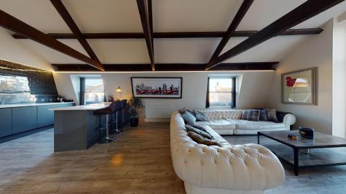 a living room with a couch and a table at Barbican Boutique Luxury Apartments & Rooms, Plymouth in Plymouth