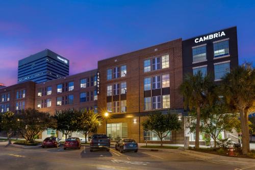 a building with cars parked in a parking lot at Cambria Hotel Columbia Downtown the Vista in Columbia