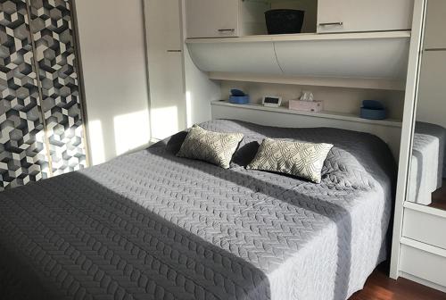 een bed met twee kussens in een slaapkamer bij Appartement en plein cœur d'Aix-les-Bains in Aix-les-Bains