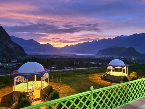 a view from the balcony of a house with a gazebo at Hotel Mountain Lodge Skardu in Skardu