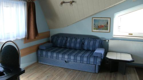 a couch in a living room with a window at Willa pod piórem in Szczyrk