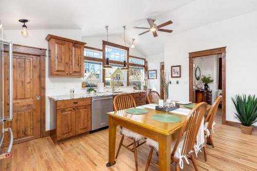 a kitchen and dining room with a wooden table and chairs at The Beautiful Bears Den! Walk to Old Town and CSU! in Fort Collins