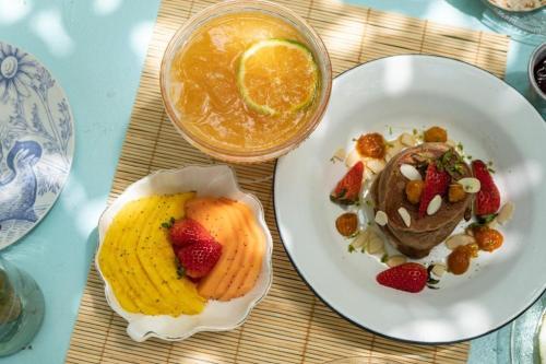 a plate of food with fruit and a drink on a table at Casa Celeste Honda in Honda