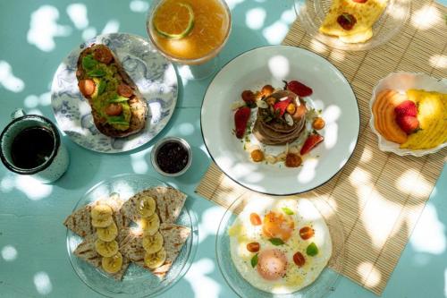 a table topped with plates of food and drinks at Casa Celeste Honda in Honda