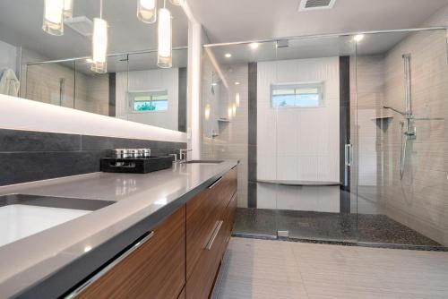 a bathroom with a sink and a shower in it at Relaxing in Paradise with Private Rooftop Deck! in Fort Collins