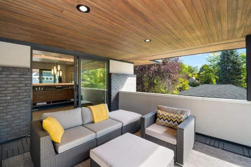 a patio with a couch and two chairs and a table at Relaxing in Paradise with Private Rooftop Deck! in Fort Collins