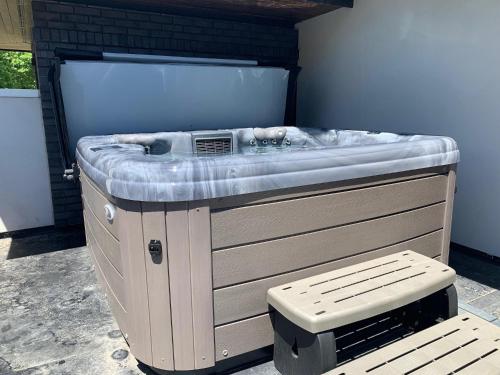 a hot tub sitting in a room with a bench at Relaxing in Paradise with Private Rooftop Deck! in Fort Collins