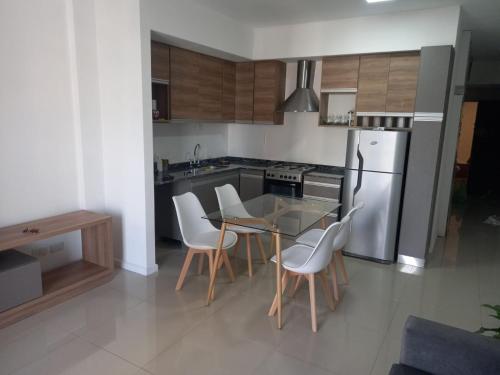 a kitchen with a table and chairs and a refrigerator at Apartamento 2 Ambientes - Moderno totalmente Amoblado in Buenos Aires