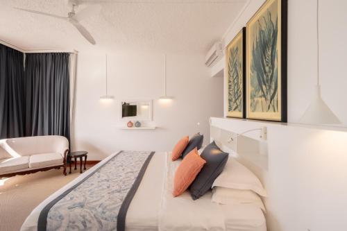 a hotel room with a bed and a couch at Villa Cambier by muse villas in Le Morne