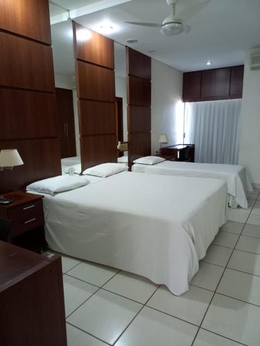 Katil atau katil-katil dalam bilik di Ibituruna Center Hotel