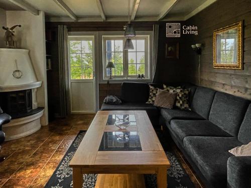 a living room with a couch and a coffee table at Great apartment in Trysil, ski inout, wifi, sauna in Trysil
