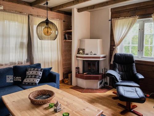 a living room with a blue couch and a table at Flat in Trysil Ski in ski out and sauna in Trysil