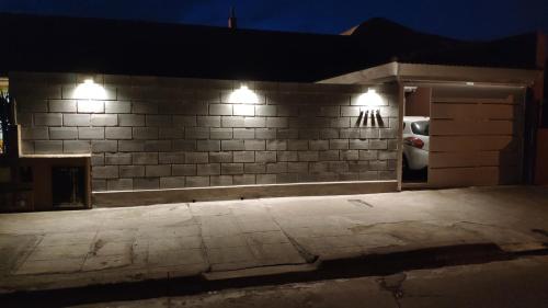 a brick wall with lights on it at night at Lo de Lucas in Olavarría