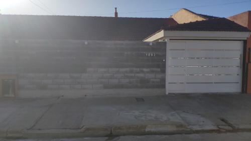 a building with a white door and some stairs at Lo de Lucas in Olavarría