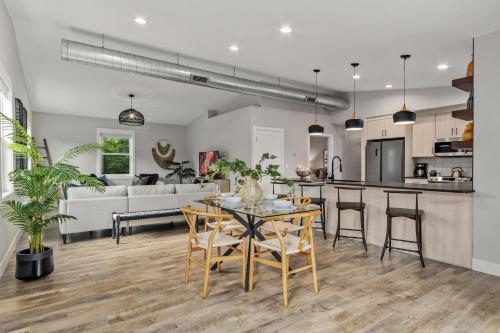a kitchen and living room with a table and chairs at Spacious Downtown Apartment - Walk to Old Town FC! in Fort Collins
