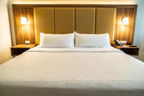 a large white bed in a hotel room at Holiday Inn Express & Suites - Ensenada Centro by IHG in Ensenada