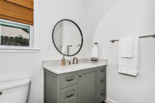 a bathroom with a sink and a mirror at Peach's Place in Pensacola