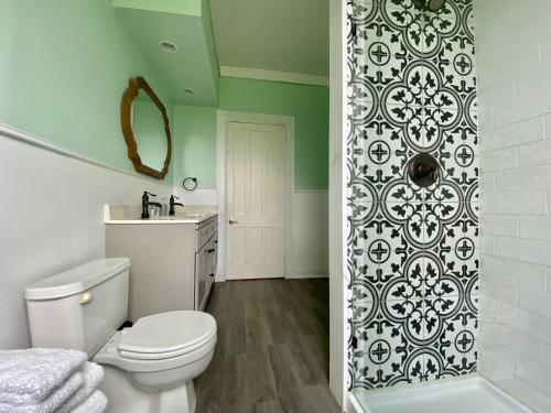 a bathroom with a toilet and a sink and a shower at Bloom Farm Guesthouse in Mount Vision