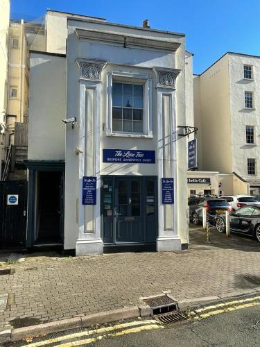 a building on a street with cars parked in a parking lot at Studio Flat Central Cheltenham Parking off road in Cheltenham