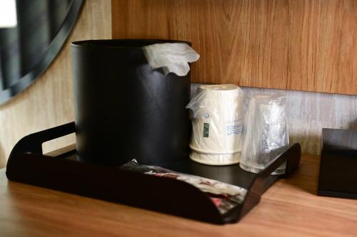 a counter top with a black container on a table at Days Inn by Wyndham Bronx NYC in Bronx
