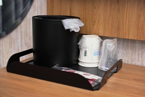 a black container sitting on top of a table at Days Inn by Wyndham Bronx NYC in Bronx