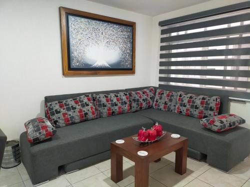 a living room with a couch and a table at Luxury departament Centenario in Guadalajara
