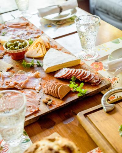 a table with cheese and meats on a cutting board at Casa Lila in Mendoza