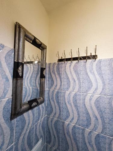 a bathroom with a mirror and blue and white tile at Terrace House in Marrakesh