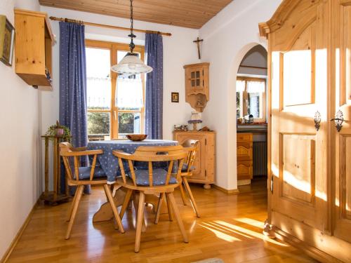 a kitchen and dining room with a table and chairs at Landhaus Albrecht in Mittenwald