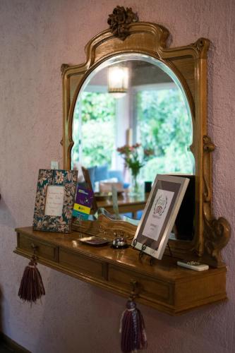 a mirror on top of a wooden shelf at Casa Lila in Mendoza