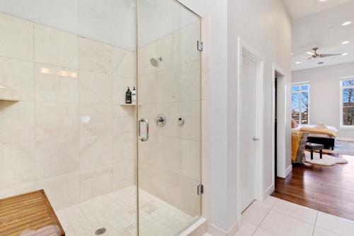 a bathroom with a shower with a glass door at The Penthouse Loft in the Heart of Old Town! in Fort Collins
