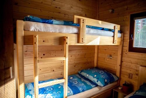 two bunk beds in a log cabin at Houseboat Bonanza Prague in Prague