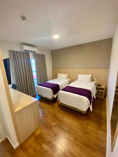 Cama o camas de una habitación en Legacy Hotel Guaratinguetá - Ao lado de Aparecida -SP