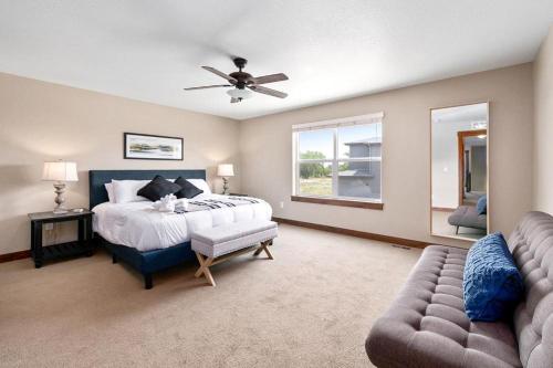 a large bedroom with a bed and a couch at Spectacular Home near Breweries & River District! in Fort Collins