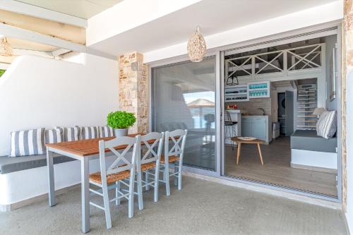 a kitchen and dining room with a table and chairs at Pallas Seaside 1 in Athens