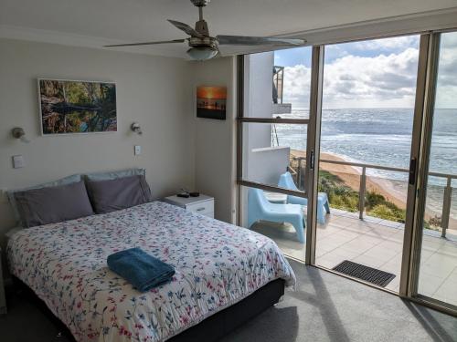 A bed or beds in a room at Toowoon Bay Beachfront Apartment
