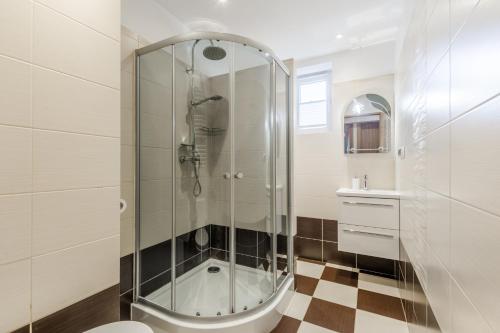 een badkamer met een douche, een toilet en een wastafel bij Apartament Księżycowy Sopot in Sopot