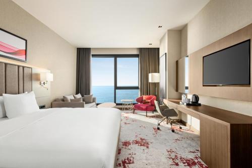 a hotel room with a bed and a view of the ocean at Ramada by Wyndham Rize Findikli in Rize