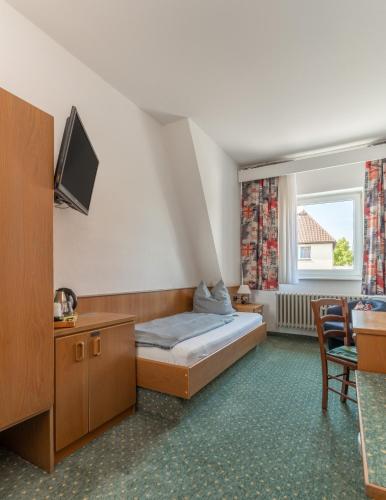 Ένα ή περισσότερα κρεβάτια σε δωμάτιο στο Hotel Kniestedter Hof