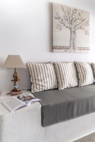 a couch with pillows and a table with a lamp at Pallas Seaside 1 in Athens