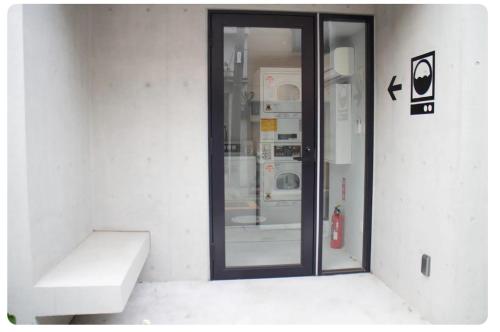 a room with a glass door in a building at The Aoca Tokyo Sanno in Tokyo