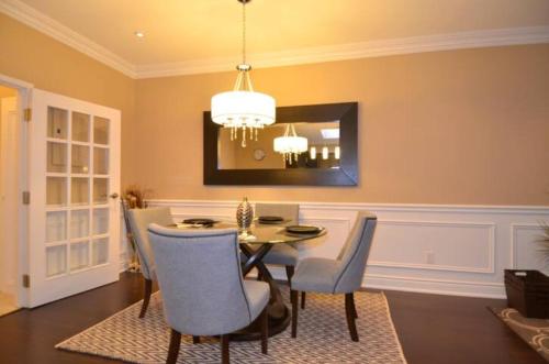 a dining room with a table and chairs at The SoMa Furnished Residences in Hamilton