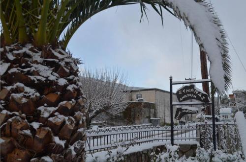 a fence covered in snow in front of a restaurant at Xenonas Anopolis 2 in Anopoli Sfakion