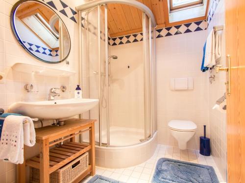 a bathroom with a shower and a sink and a toilet at Landhaus Albrecht in Mittenwald
