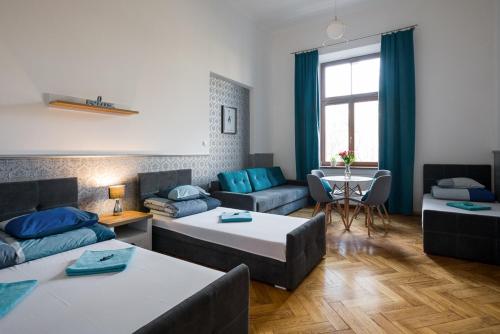 a living room with two beds and a table at Near the Royal Castle in Krakow